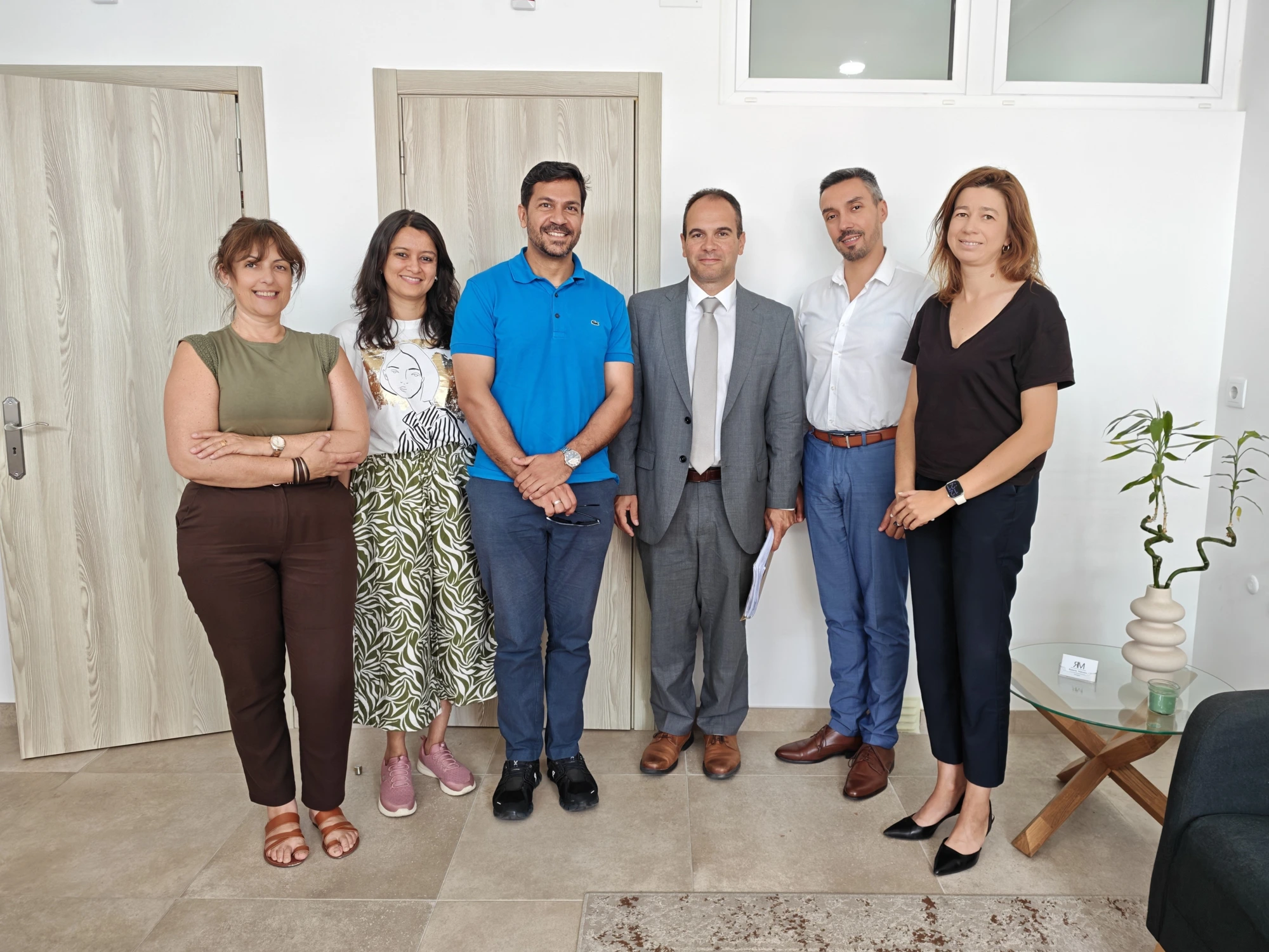 Diogo Almeida with clients and partners at the office after completing a mortgage in the Algarve